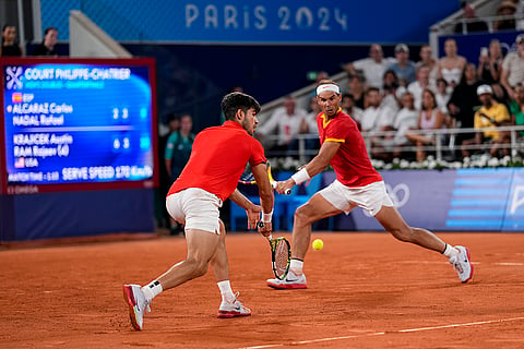 Carlos Alcaraz return the ball against Austin Krajicek and Rajeev Ram